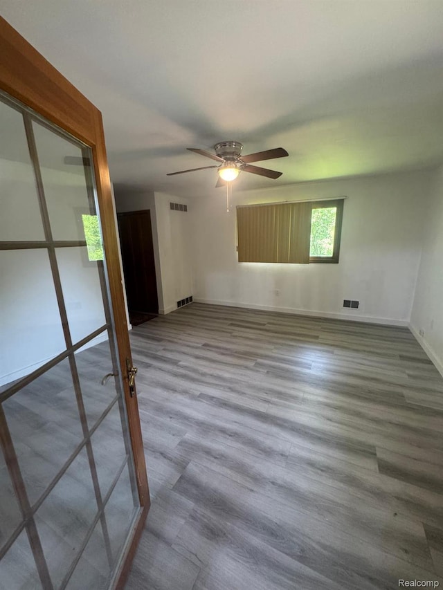 21451 N Nunneley Rd, Shelby Twp, MI 48036 - spare room with ceiling fan, baseboards, and wood finished floors