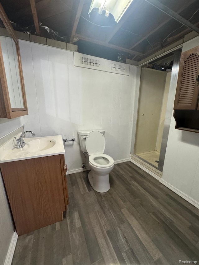21451 N Nunneley Rd, Shelby Twp, MI 48036 - full bath with vanity, wood finished floors, toilet, a shower stall, and baseboards