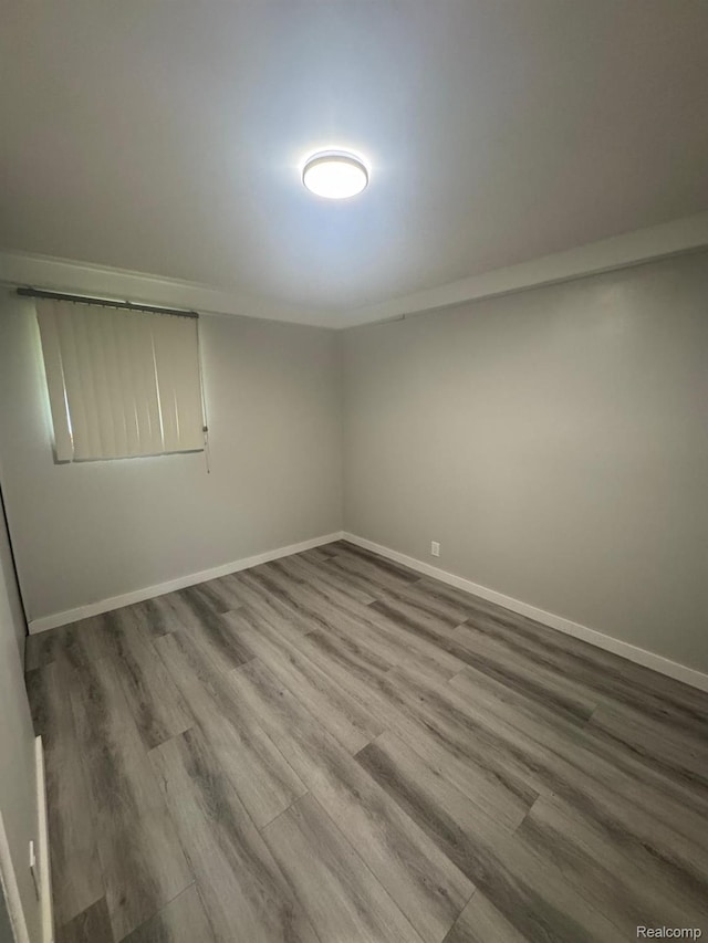 21451 N Nunneley Rd, Shelby Twp, MI 48036 - spare room featuring wood finished floors and baseboards