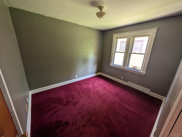 1712 S Hamilton St, Saginaw, MI 48602 - empty room with dark carpet and baseboards