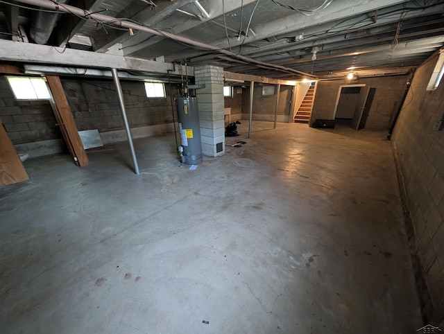 1712 S Hamilton St, Saginaw, MI 48602 - basement with water heater, stairs, and plenty of natural light