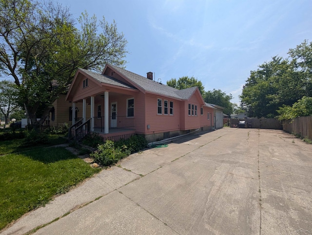 1712 S Hamilton St, Saginaw, MI 48602 - view of property exterior with covered porch and roof with shingles