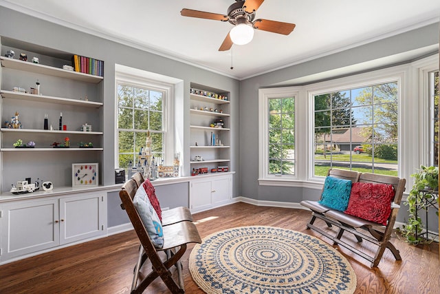 3225 Bronson Blvd, Kalamazoo, MI 49008 - living area with wood finished floors, plenty of natural light, built in shelves, a ceiling fan, and ornamental molding