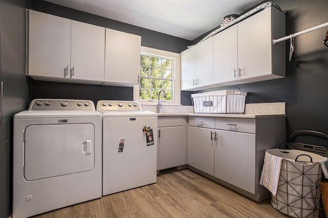 3225 Bronson Blvd, Kalamazoo, MI 49008 - laundry area with cabinet space, separate washer and dryer, and light wood-type flooring