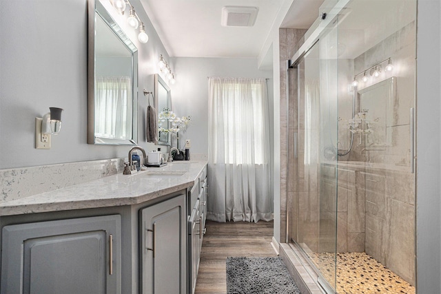 3225 Bronson Blvd, Kalamazoo, MI 49008 - bathroom with vanity, a shower stall, and wood finished floors