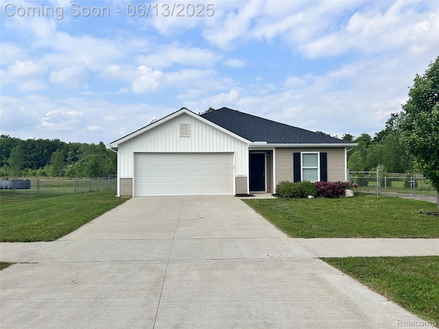 9145 Magnolia Ct, Davison, MI 48423 - view of front of home featuring concrete driveway, an attached garage, board and batten siding, and roof with shingles