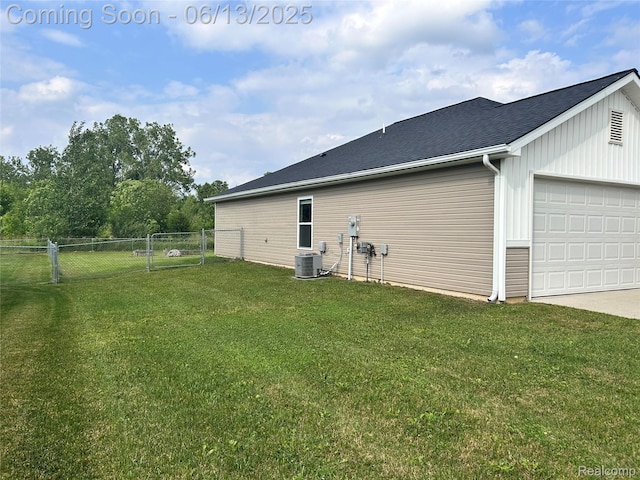 9145 Magnolia Ct, Davison, MI 48423 - rear view of property featuring cooling unit, concrete driveway, an attached garage, board and batten siding, and roof with shingles