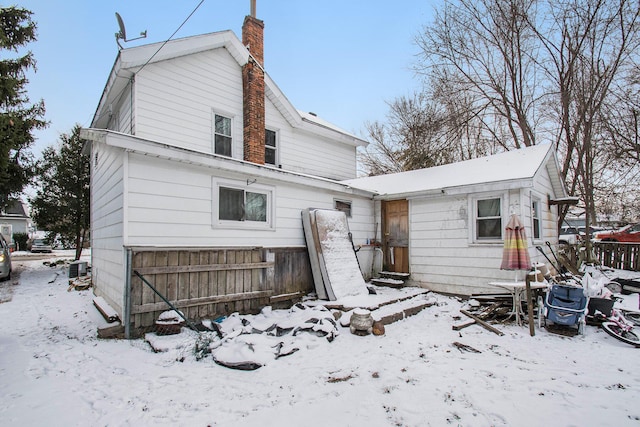 309 N Front St, Dowagiac, MI 49047 - snow covered rear of property with a chimney