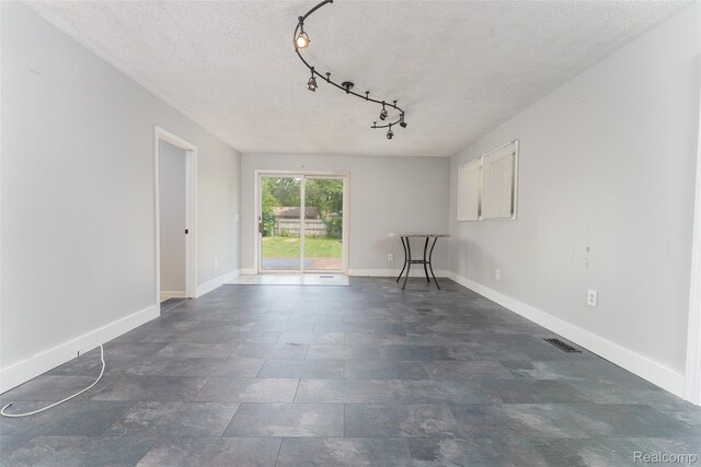 3260 Van Campen Dr, Waterford, MI 48329 - spare room with a textured ceiling, baseboards, and rail lighting