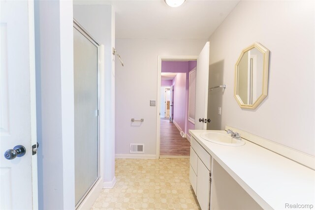 3260 Van Campen Dr, Waterford, MI 48329 - bathroom with a shower stall, vanity, baseboards, and tile patterned floors