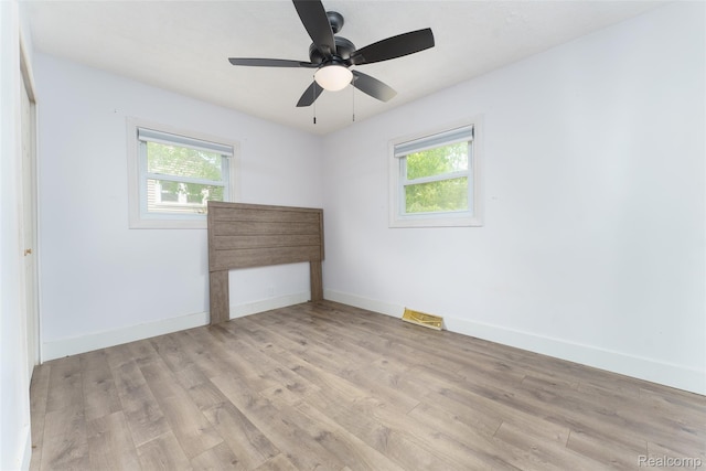 3260 Van Campen Dr, Waterford, MI 48329 - spare room featuring plenty of natural light, wood finished floors, baseboards, and ceiling fan