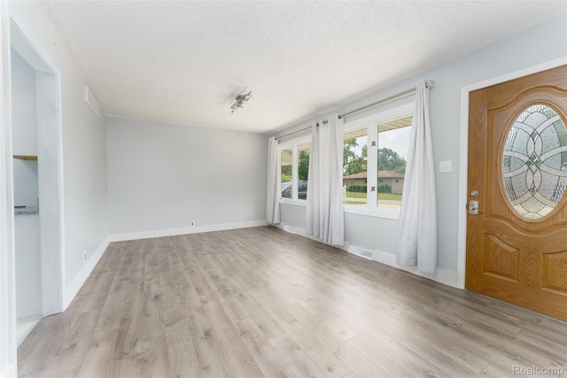 3260 Van Campen Dr, Waterford, MI 48329 - entryway with plenty of natural light, a textured ceiling, light wood-style floors, and baseboards