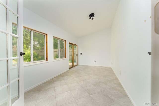 3260 Van Campen Dr, Waterford, MI 48329 - spare room with baseboards, lofted ceiling, and light tile patterned floors