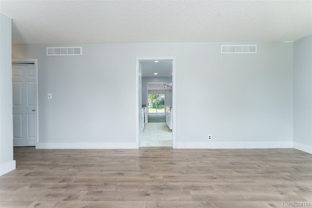 3260 Van Campen Dr, Waterford, MI 48329 - unfurnished room featuring wood finished floors, baseboards, and a textured ceiling