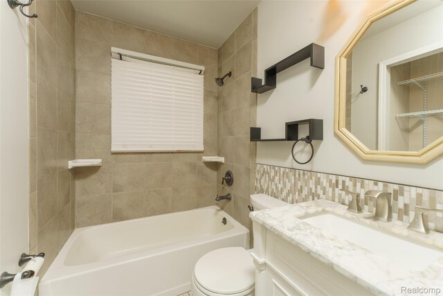 3260 Van Campen Dr, Waterford, MI 48329 - full bathroom with toilet, tub / shower combination, vanity, and tile walls