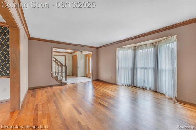 2456 Red Maple Dr, Troy, MI 48098 - unfurnished room with crown molding, stairs, and wood finished floors