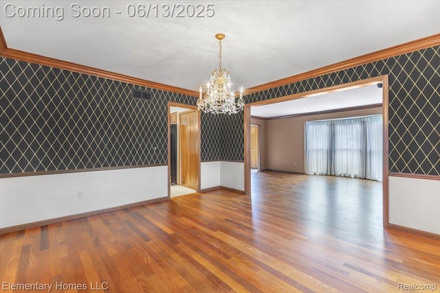 2456 Red Maple Dr, Troy, MI 48098 - unfurnished room with crown molding, a chandelier, wood finished floors, and wallpapered walls