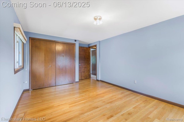 2456 Red Maple Dr, Troy, MI 48098 - unfurnished bedroom featuring wood finished floors and a closet