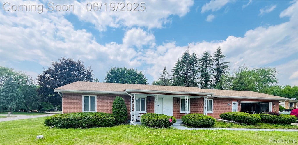 5095 Camborne Ct, Flint, MI 48504 - single story home with brick siding, a front lawn, a porch, and an attached garage