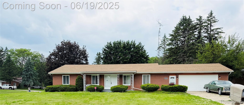 5095 Camborne Ct, Flint, MI 48504 - ranch-style home with a garage, a front lawn, brick siding, and driveway