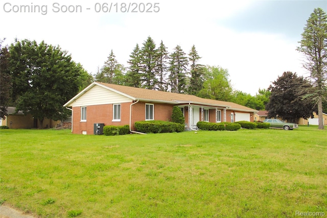 5095 Camborne Ct, Flint, MI 48504 - single story home with an attached garage, a front lawn, and brick siding