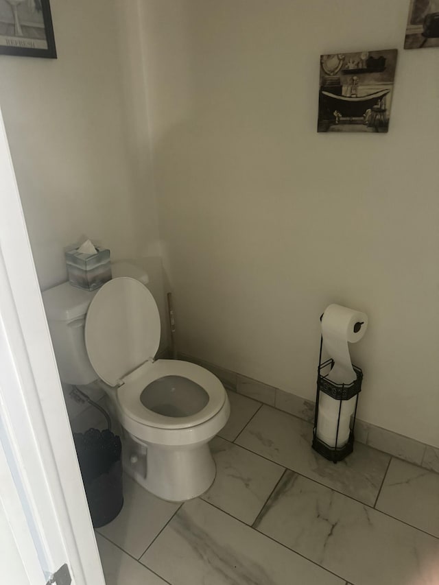 25045 Glenbrooke Dr, Southfield, MI 48033 - bathroom featuring toilet and marble look tiles