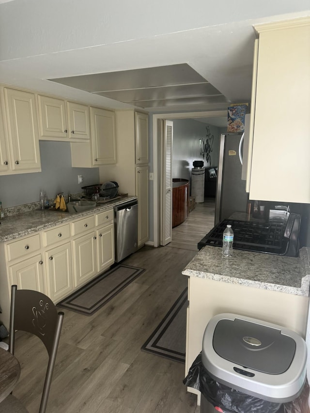 25045 Glenbrooke Dr, Southfield, MI 48033 - kitchen featuring appliances with stainless steel finishes, cream cabinets, wood finished floors, and light stone countertops