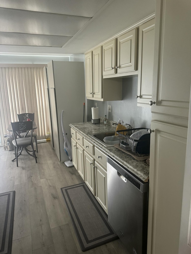 25045 Glenbrooke Dr, Southfield, MI 48033 - kitchen with dishwasher, wood finished floors, cream cabinets, and dark countertops