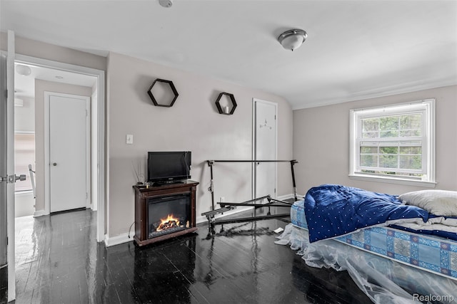 11603 Lansdowne St, Detroit, MI 48224 - bedroom featuring a glass covered fireplace and wood finished floors
