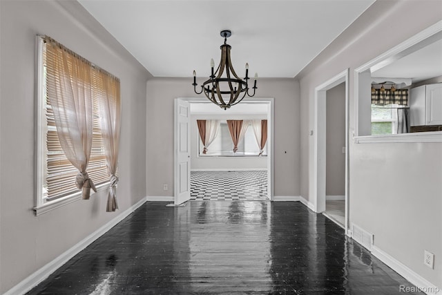 11603 Lansdowne St, Detroit, MI 48224 - unfurnished dining area featuring a chandelier and wood finished floors
