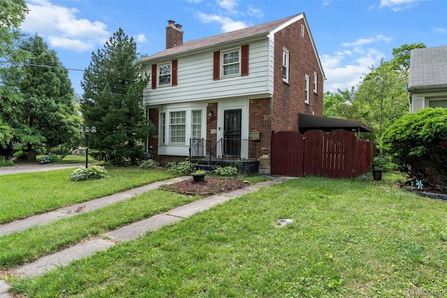 11603 Lansdowne St, Detroit, MI 48224 - colonial home featuring brick siding, a gate, a chimney, and a front lawn