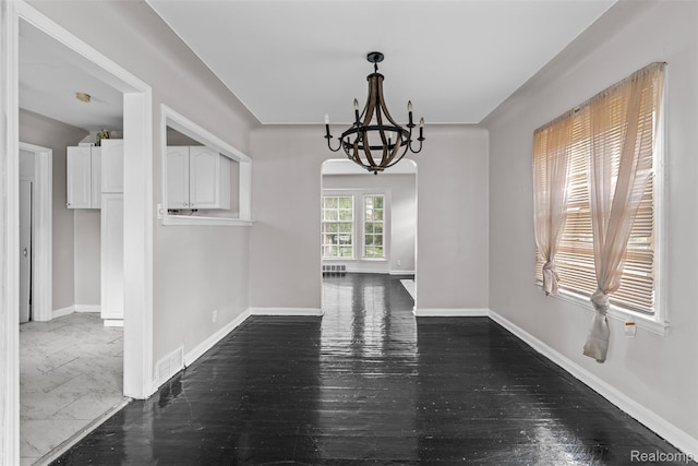 11603 Lansdowne St, Detroit, MI 48224 - unfurnished dining area featuring a chandelier, dark wood-style floors, and arched walkways