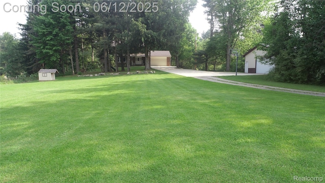 5836 Ewalt Rd, Imlay City, MI 48444 - view of green lawn featuring a storage shed