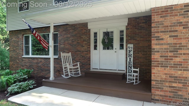 5836 Ewalt Rd, Imlay City, MI 48444 - doorway to property featuring covered porch and brick siding