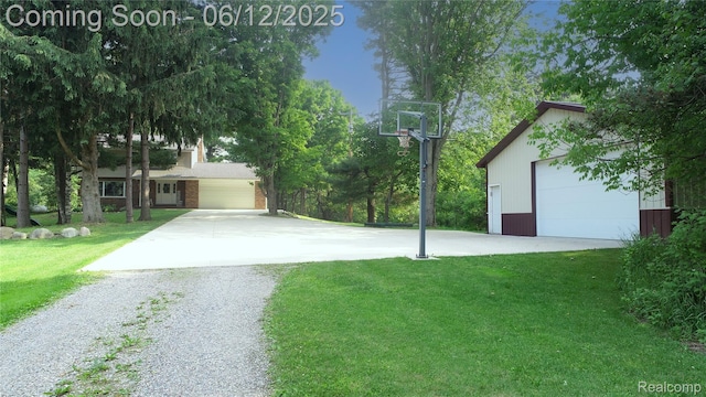 5836 Ewalt Rd, Imlay City, MI 48444 - view of grassy yard featuring gravel driveway, a garage, and an outdoor structure