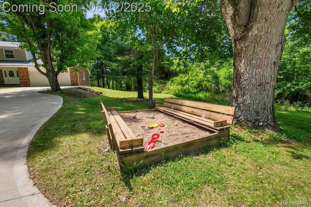 5836 Ewalt Rd, Imlay City, MI 48444 - view of home's community featuring a yard, concrete driveway, and a garage