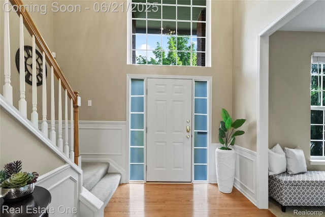 7244 Millrock Ave, Shelby Twp, MI 48317 - entrance foyer with wainscoting, stairway, light wood finished floors, and a decorative wall