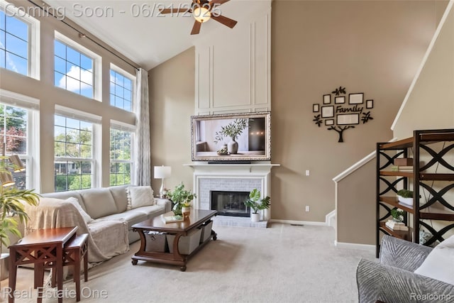 7244 Millrock Ave, Shelby Twp, MI 48317 - carpeted living room featuring high vaulted ceiling, ceiling fan, and a fireplace