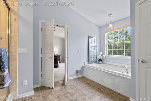 7244 Millrock Ave, Shelby Twp, MI 48317 - bathroom with a bath, lofted ceiling, tiled shower, and tile patterned floors