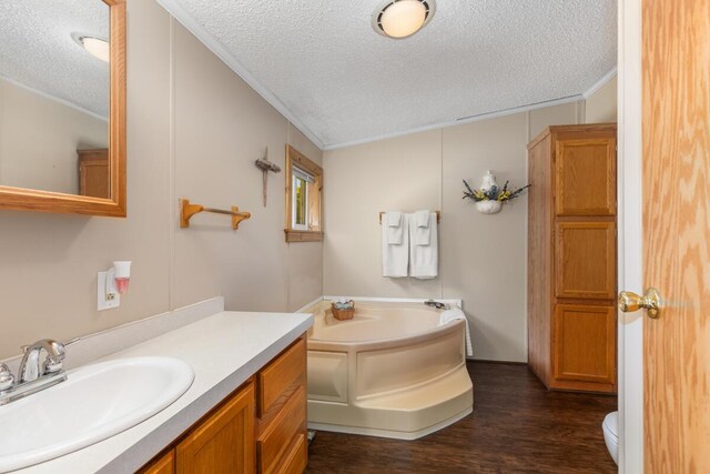 3858 S Chestnut Ave, Newaygo, MI 49337 - bathroom featuring a textured ceiling, crown molding, a bath, vanity, and wood finished floors