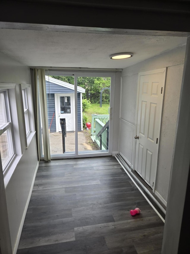 1420 Sweet St, Saginaw, MI 48602 - spare room with baseboards and dark wood-type flooring