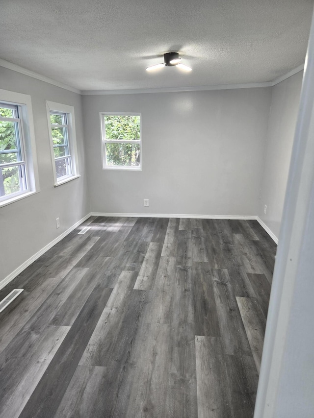1420 Sweet St, Saginaw, MI 48602 - unfurnished room featuring a textured ceiling, dark wood-type flooring, ornamental molding, and baseboards