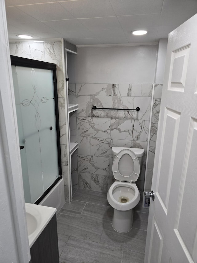1420 Sweet St, Saginaw, MI 48602 - bathroom featuring tile walls, toilet, vanity, and shower / bathtub combination