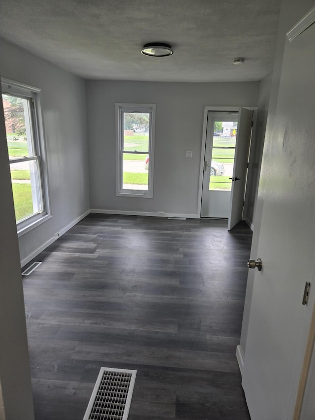 1420 Sweet St, Saginaw, MI 48602 - spare room with baseboards and dark wood-style flooring