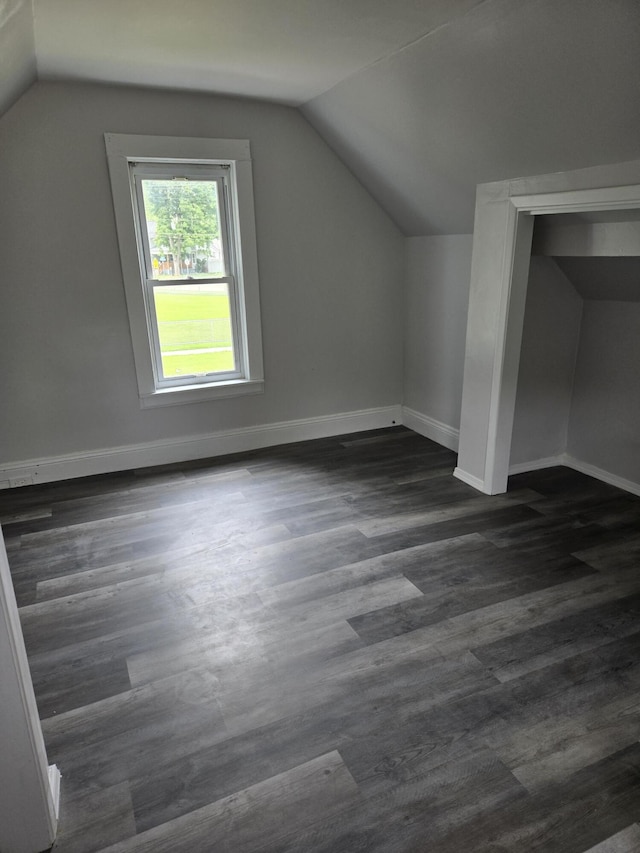 1420 Sweet St, Saginaw, MI 48602 - bonus room featuring lofted ceiling, baseboards, and dark wood-type flooring