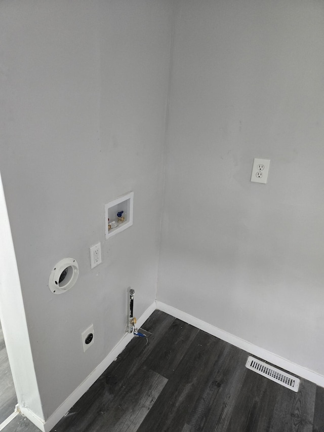 1420 Sweet St, Saginaw, MI 48602 - laundry area with hookup for a gas dryer, baseboards, hookup for an electric dryer, dark wood-style flooring, and hookup for a washing machine