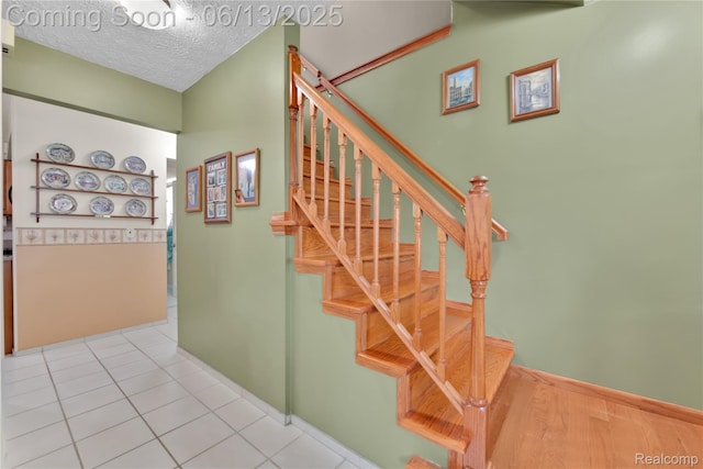 3039 Elmcrest Rd, Sterling Heights, MI 48310 - stairway with a textured ceiling and tile patterned flooring