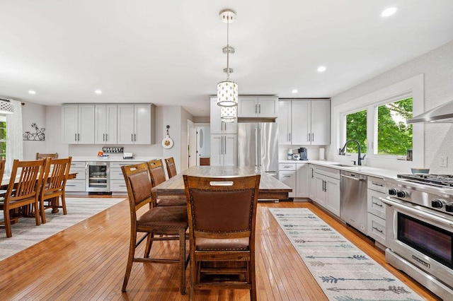 5549 Newton Ave, Coloma, MI 49038 - kitchen with high quality appliances, beverage cooler, a sink, light wood-style floors, and light countertops