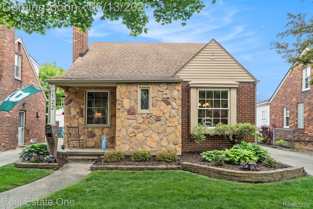 122 N Wilson Ave, Royal Oak, MI 48067 - view of front of home with roof with shingles, a chimney, and stone siding