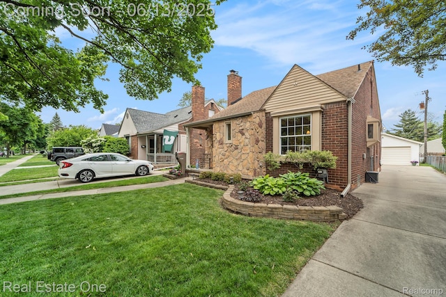 122 N Wilson Ave, Royal Oak, MI 48067 - view of front of house featuring a chimney, a front yard, an outbuilding, roof with shingles, and a garage